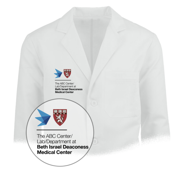 White coat example with Harvard Medical School and Affiliate icons placed on the right chest area with additional departmental name locked below
